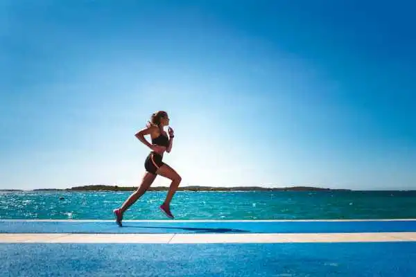 Woman running showing strong leg muscle Kingshurst